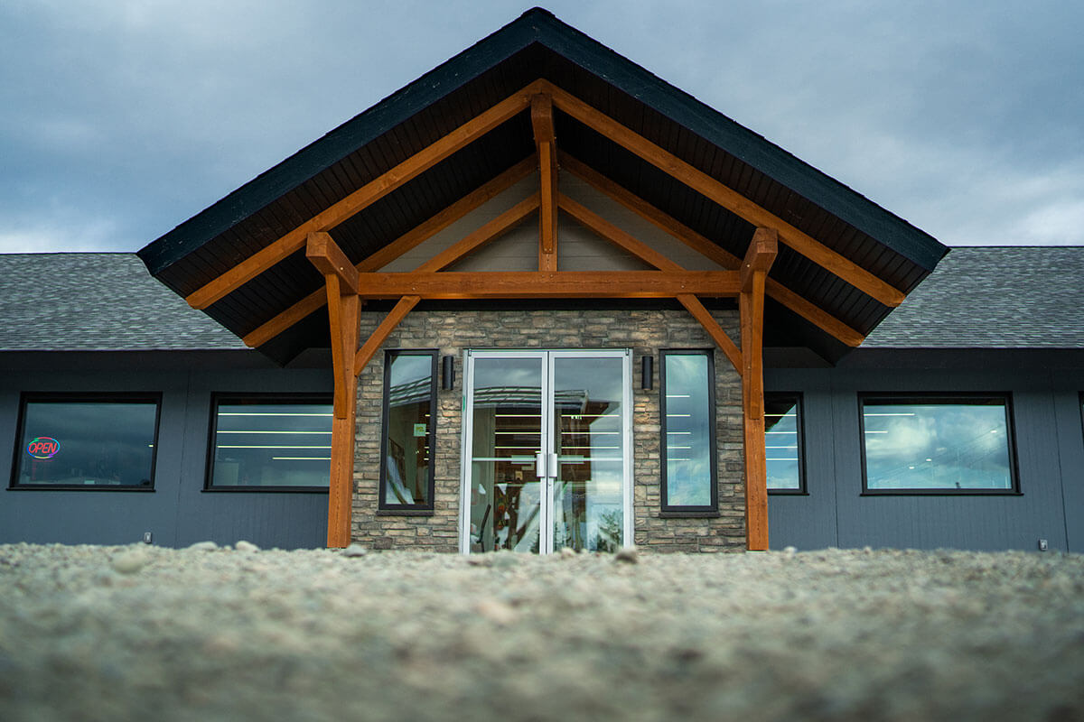 Entryway of a modern building featuring timber framing by Smith Timber Works, highlighting Canadian design and craftsmanship.