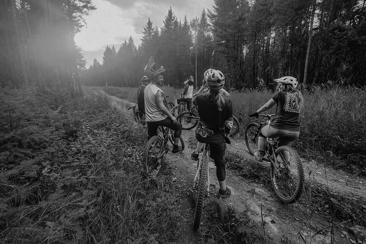 Group of mountain bikers on a forest trail in British Columbia, embracing the outdoor lifestyle that inspires Smith Timber Works.