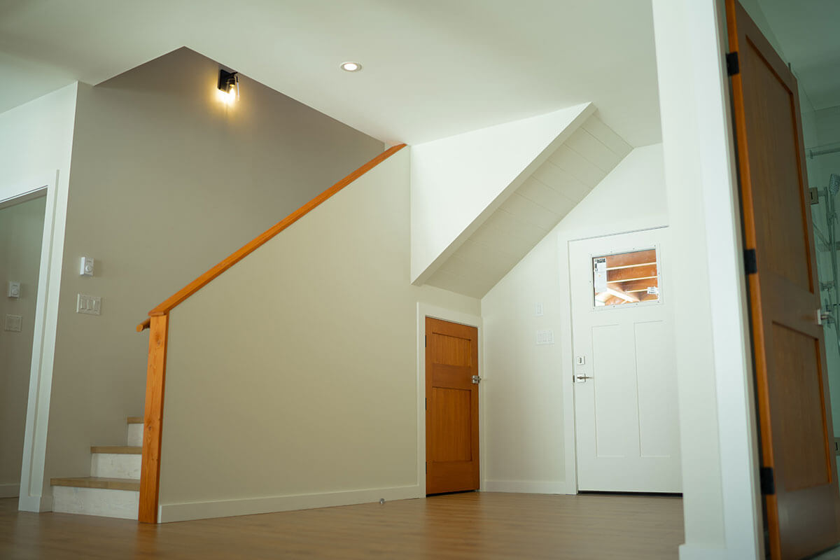 Entrance foyer with wood staircase and modern design by Smith Timber Works.