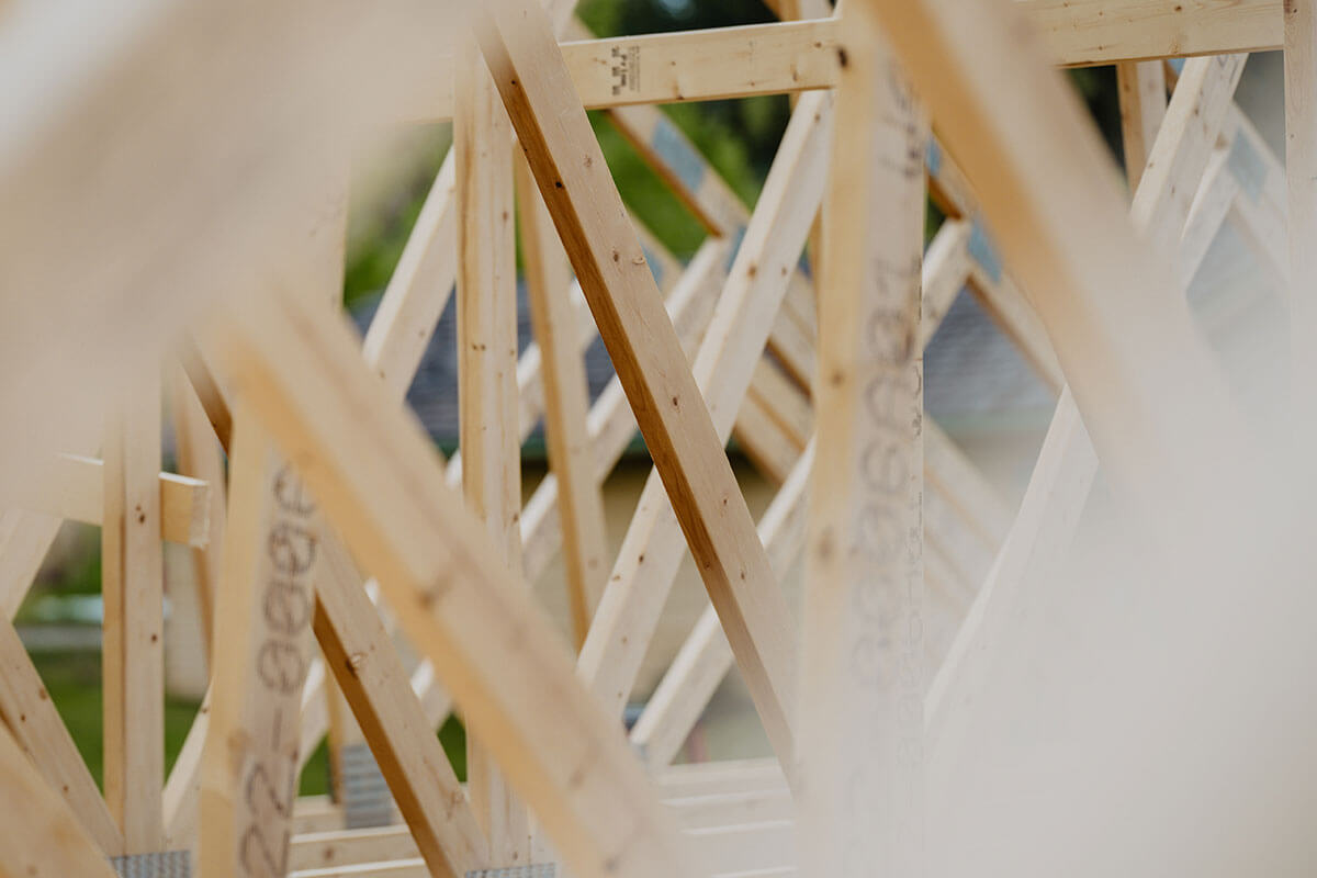 Close-up of wooden roof trusses during construction by Smith Timber Works.