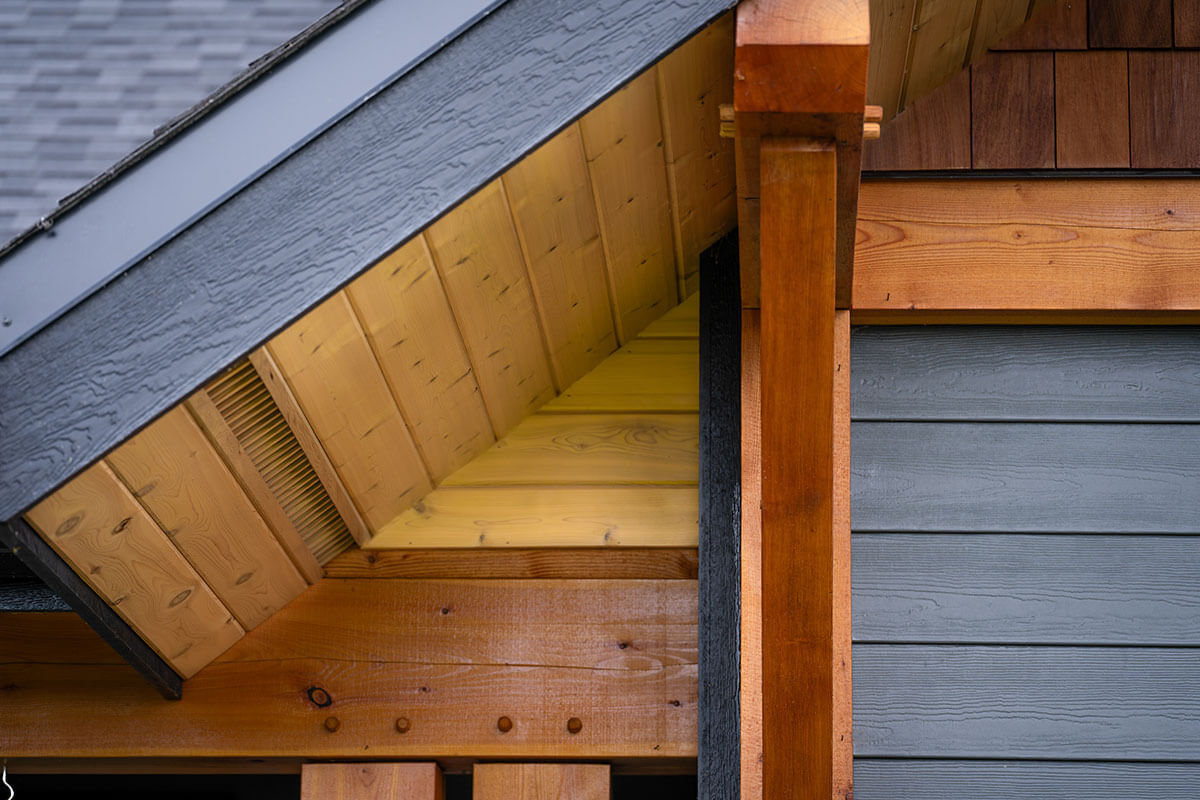 Close-up of exterior timber frame joinery, showcasing precise craftsmanship and natural wood elements by Canadian timber framers.