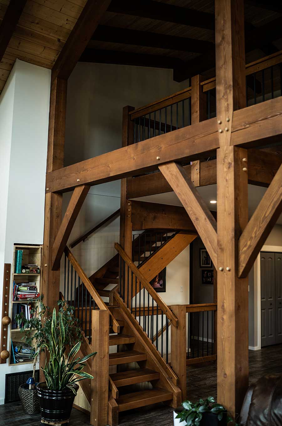 Smith Timber Works interior with structural timber frame posts and staircase.