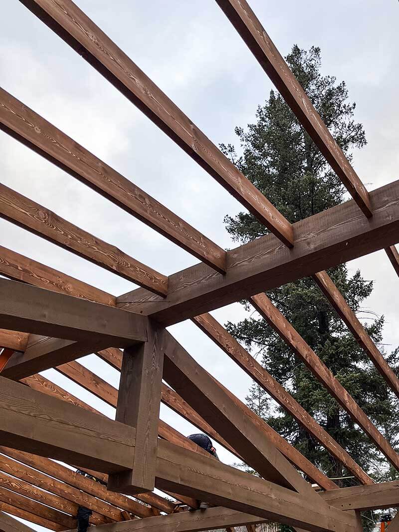 Outdoor timber framing by Smith Timber Works, showcasing robust Canadian wood construction and craftsmanship.