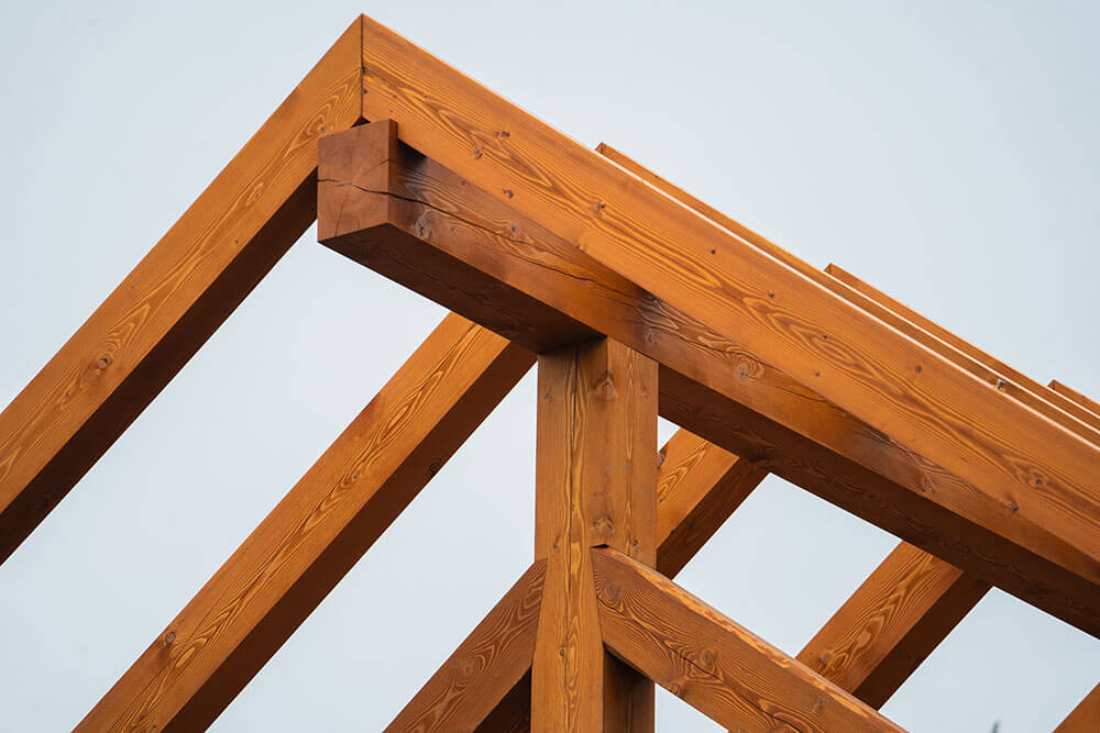 Exterior timber frame roof peak by Smith Timber Works, Canadian craftsmanship.