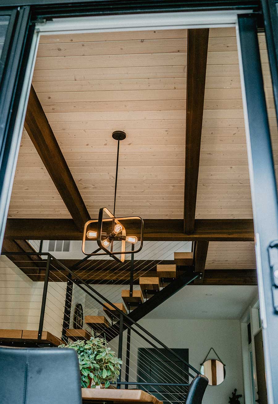 High ceiling with timber beams and wood paneling, crafted by Smith Timber Works.