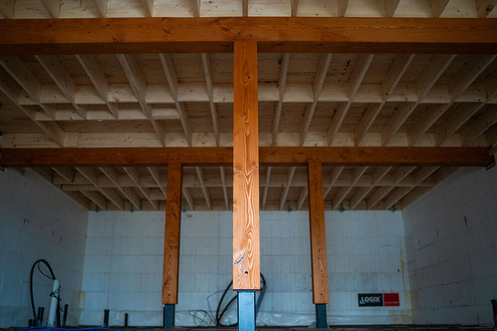 Structural timber posts and ceiling joists by Smith Timber Works, Canada.