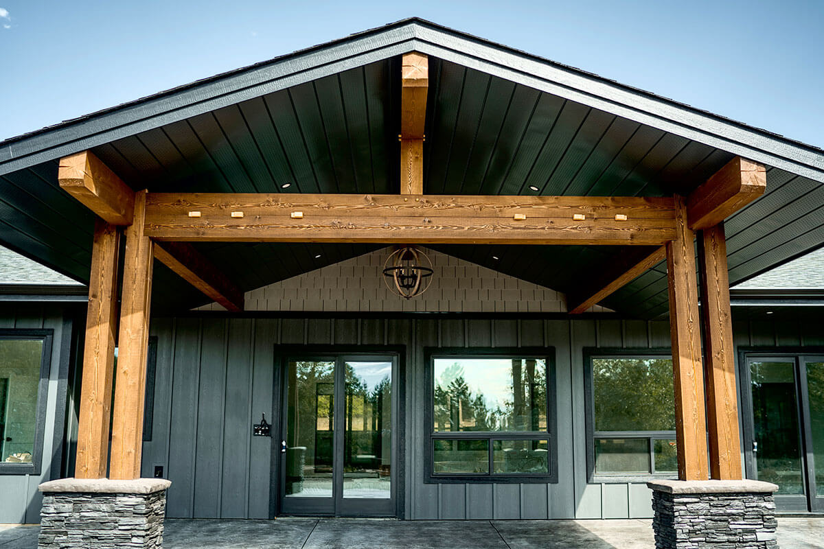Custom timber frame entry by Smith Timber Works, British Columbia.
