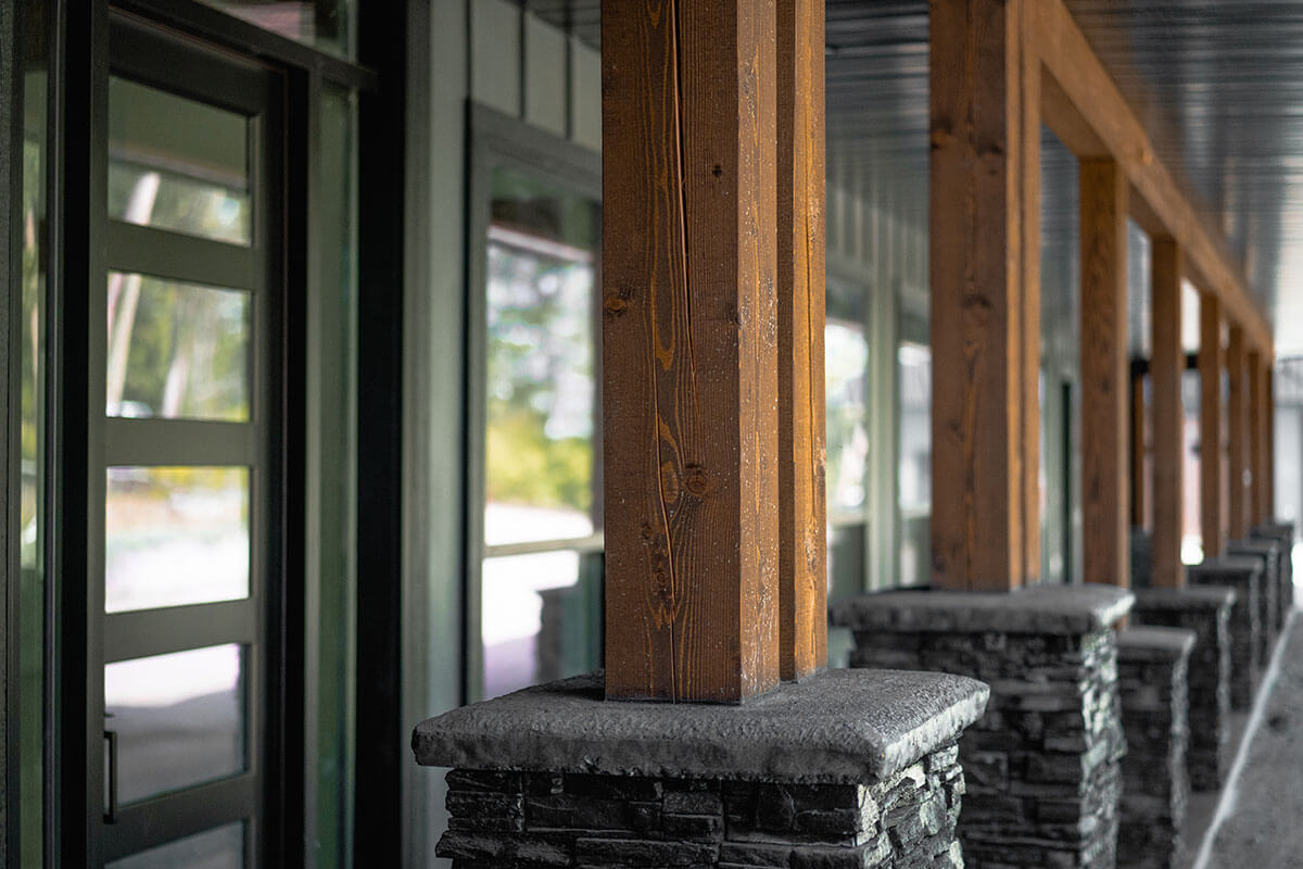 Exterior timber posts on stone bases by Smith Timber Works, Canadian design.
