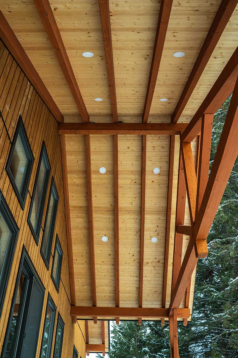Prefabricated timber porch roof with exposed beams by Smith Timber Works.