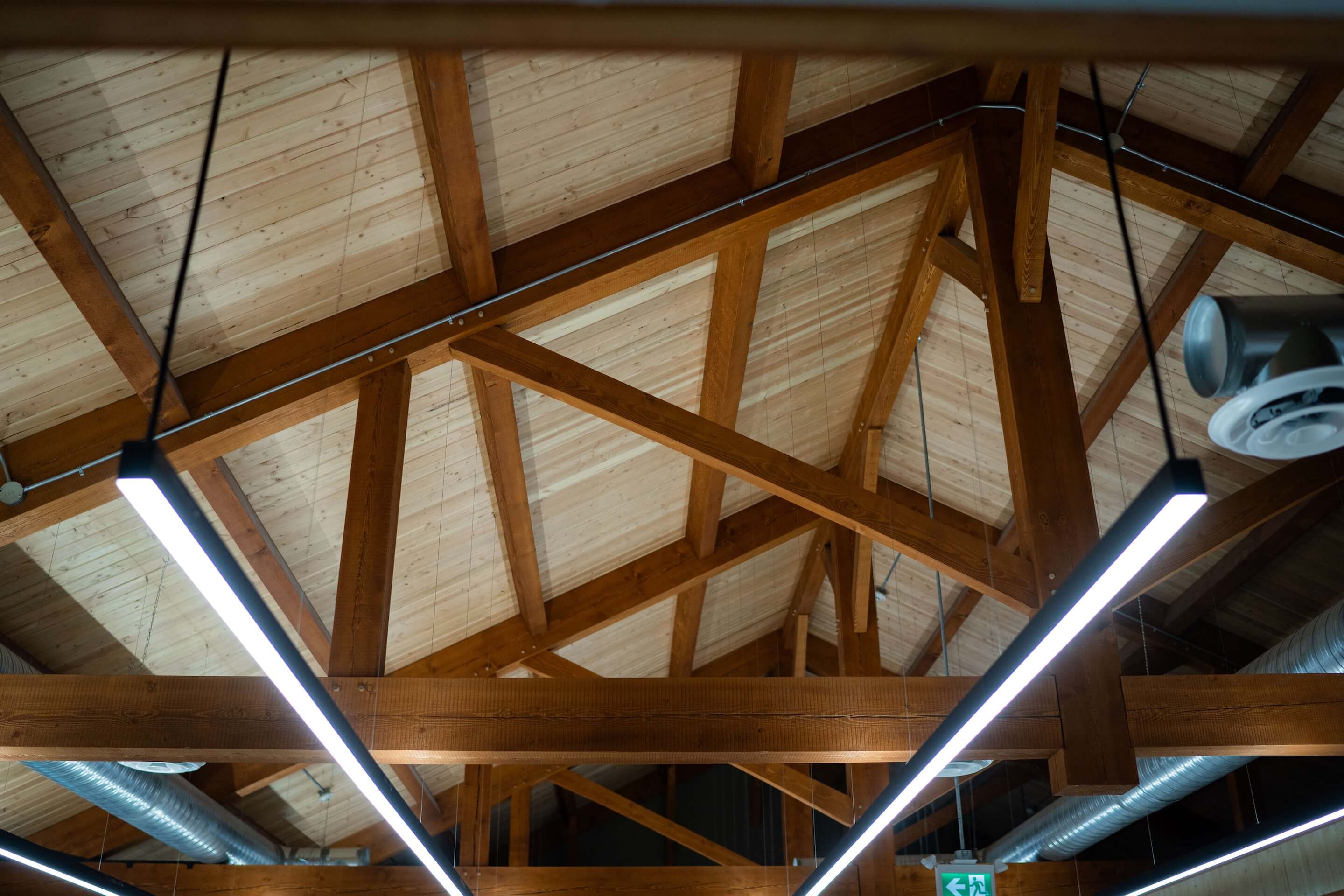 Exposed timber truss roof system by Smith Timber Works, showcasing Canadian structural design and carpentry.