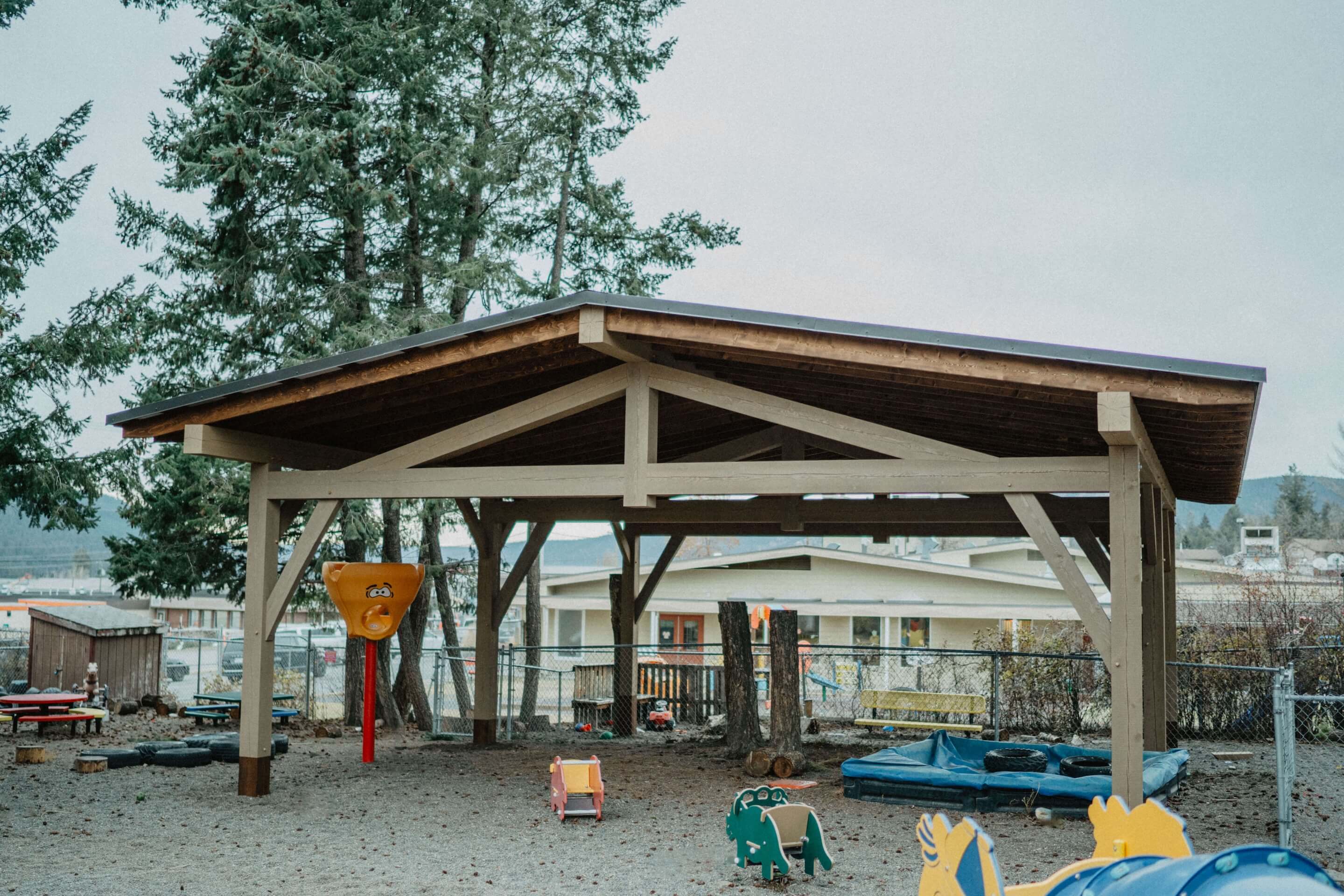 Outdoor timber frame shelter by Smith Timber Works, providing shade and structure for a Canadian community space.