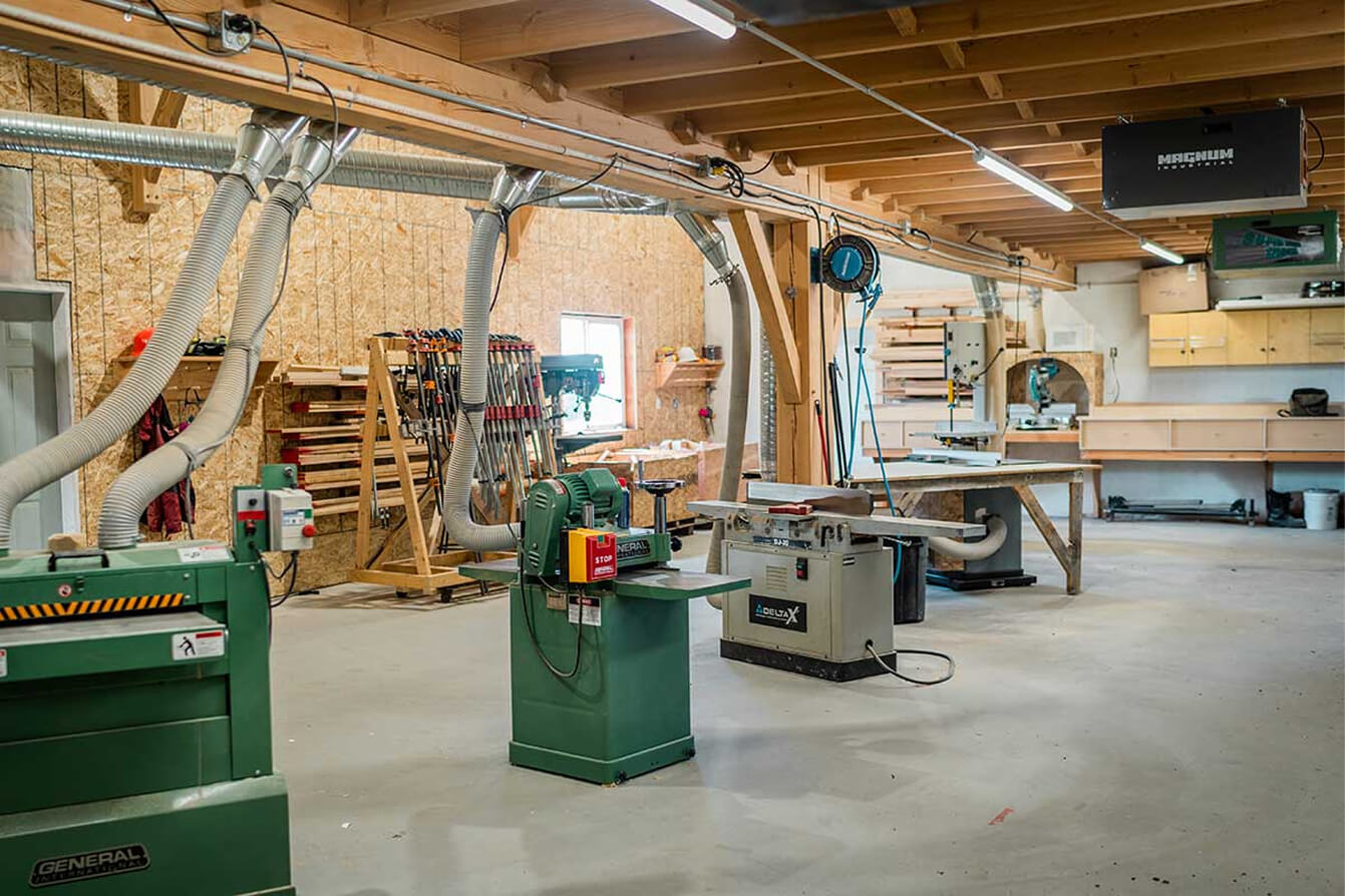 Smith Timber Works fabrication shop equipped with industrial woodworking tools and dust collection systems for timber processing.