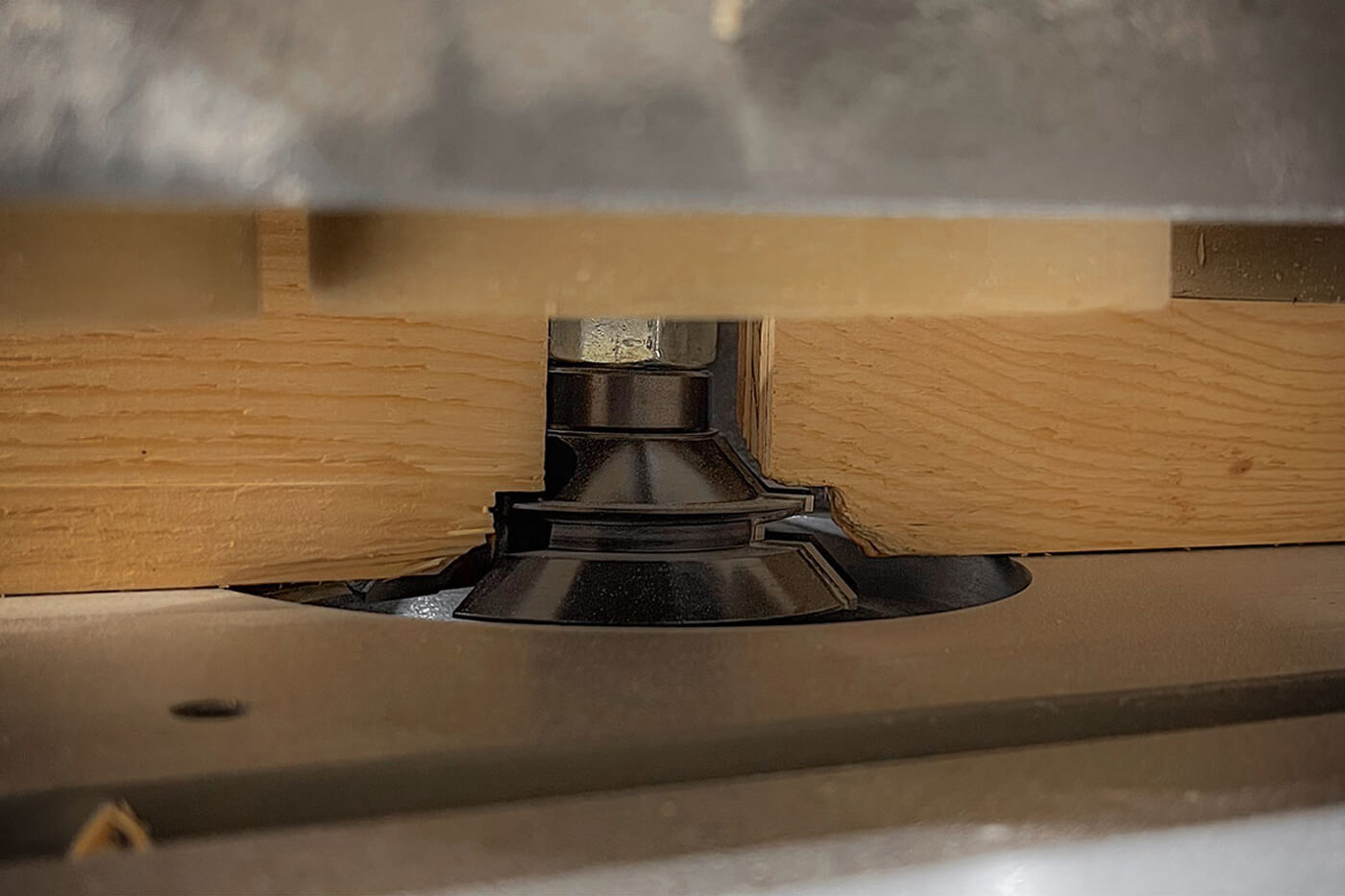 Close-up of a timber board being shaped by a router bit in Smith Timber Works’ precision milling equipment.