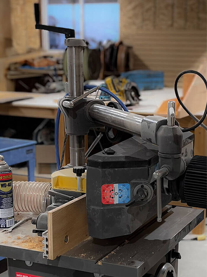 Detail of joinery machinery in use at Smith Timber Works’ fabrication shop, used for precise milling of timber components.