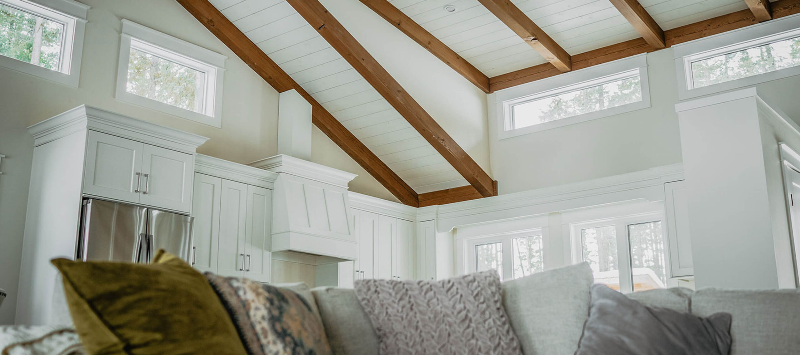 Cozy living space with vaulted timber ceiling and custom cabinetry, highlighting Smith Timber Works’ residential craftsmanship.