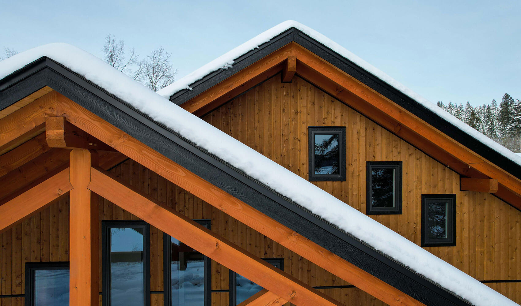 Gable roof with timber beams and snow by Smith Timber Works, British Columbia.