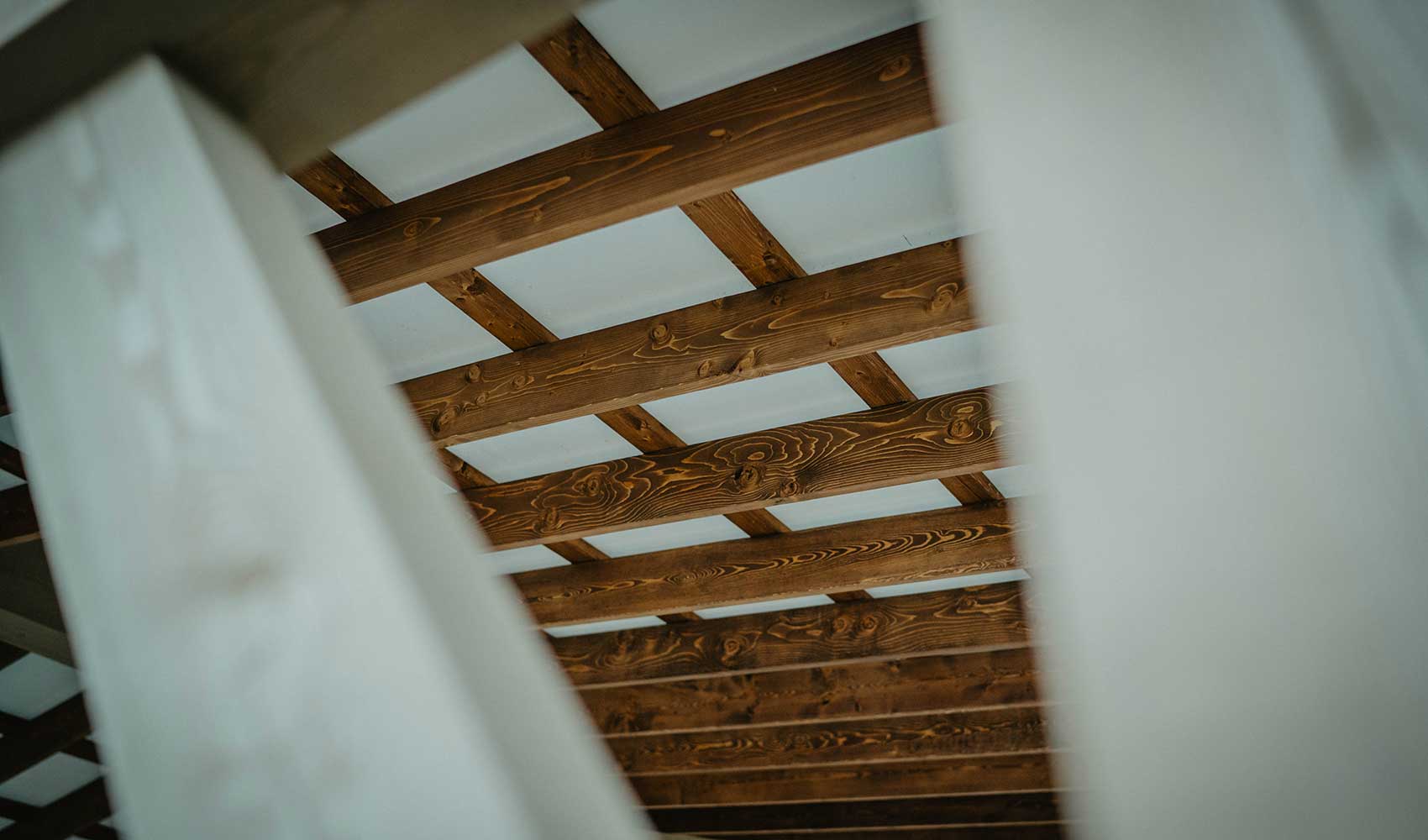Architectural detail of timber roof framing by Smith Timber Works, emphasizing Canadian craftsmanship and structural design.