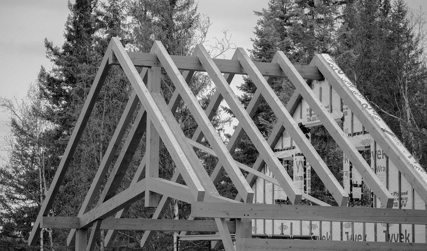 Monochrome timber frame roof structure by Smith Timber Works.