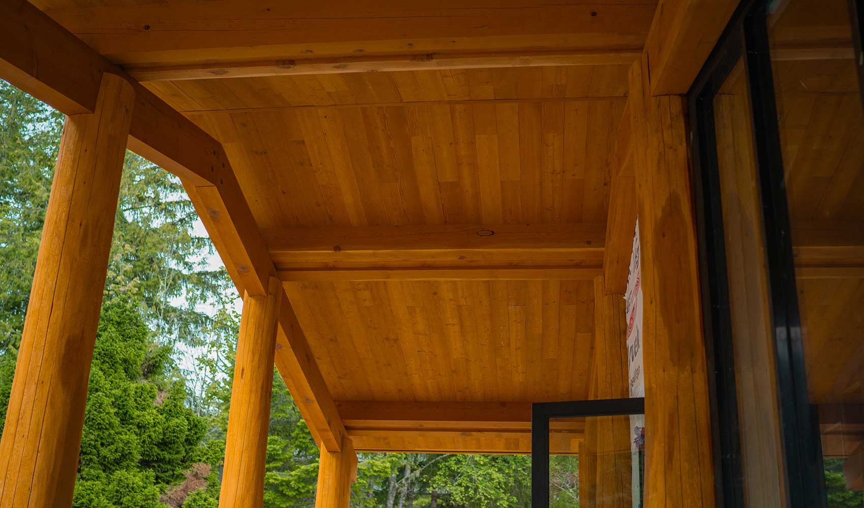 Smith Timber Works' detailed timber framing craftsmanship on a Canadian building's exterior.