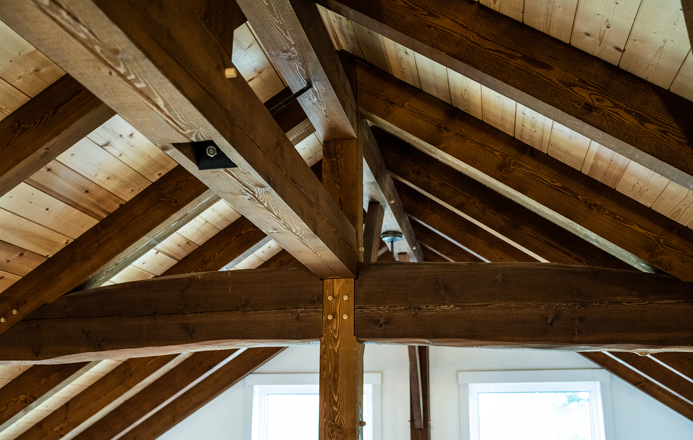 Handcrafted timber ceiling with exposed structural joinery, showcasing Smith Timber Works design and build capabilities and their attention to detail in residential timber framing.