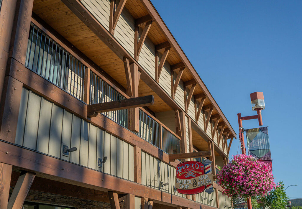 Angled view of timber-framed commercial facade with flower baskets, crafted by Smith Timber Works.