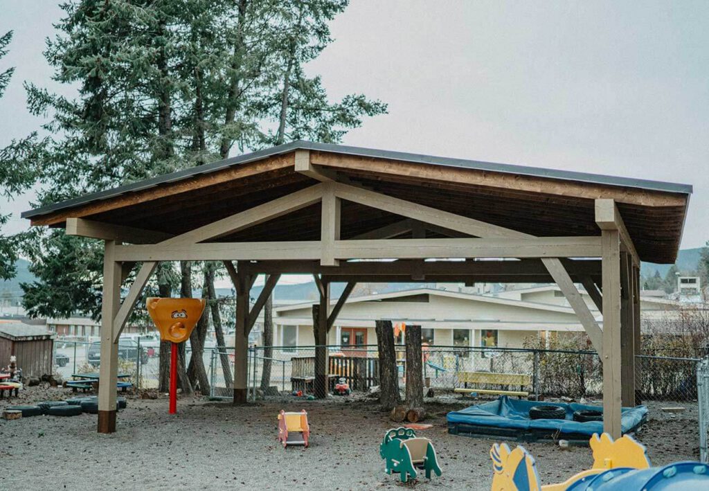Outdoor timber frame shelter by Smith Timber Works, providing shade and structure for a Canadian community space.