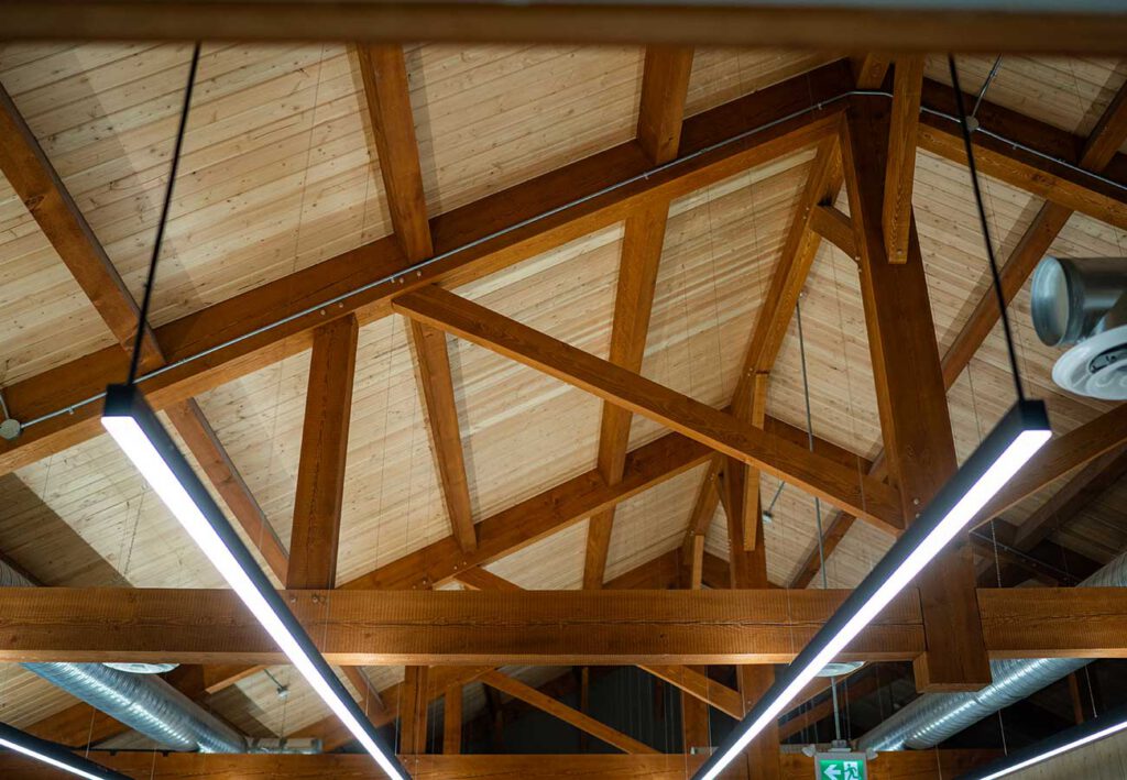 Exposed timber truss roof system by Smith Timber Works, showcasing Canadian structural design and carpentry.