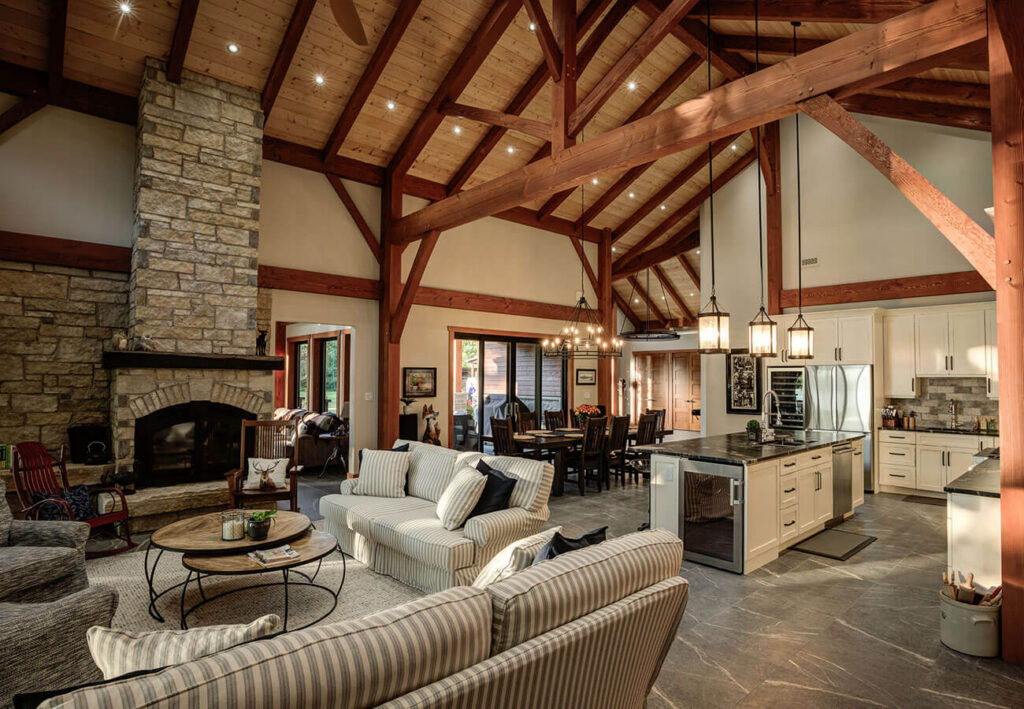 Interior of a stunning timber frame home by Smith Timber Works, showcasing soaring exposed beams, a bright open-concept living space, and elegant lighting.